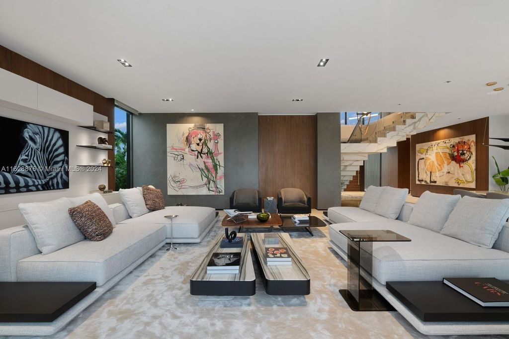 Discover an extraordinary waterfront compound in gated San Souci Estates, featuring a brand new ultra-modern home and a sophisticated guest house on a double lot.