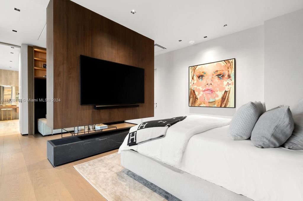 Discover an extraordinary waterfront compound in gated San Souci Estates, featuring a brand new ultra-modern home and a sophisticated guest house on a double lot.