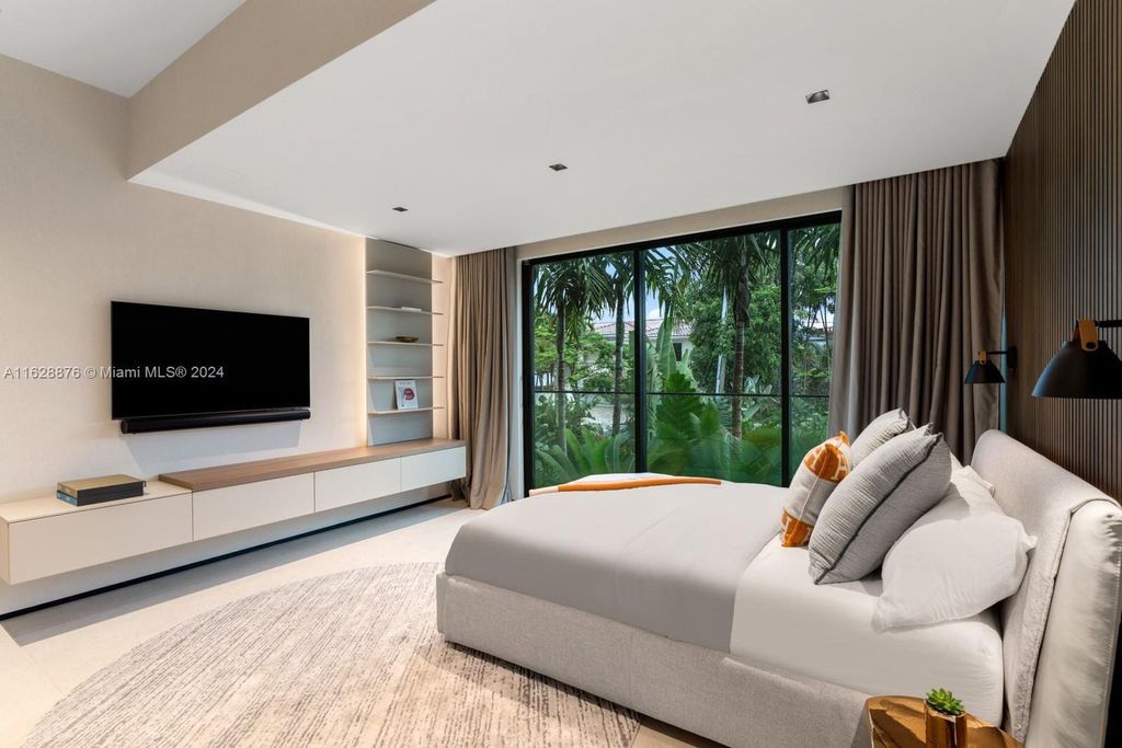 Discover an extraordinary waterfront compound in gated San Souci Estates, featuring a brand new ultra-modern home and a sophisticated guest house on a double lot.