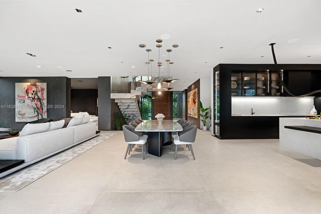Discover an extraordinary waterfront compound in gated San Souci Estates, featuring a brand new ultra-modern home and a sophisticated guest house on a double lot.