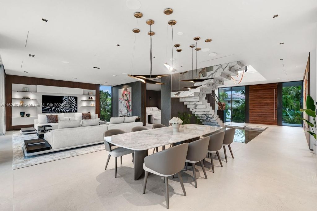Discover an extraordinary waterfront compound in gated San Souci Estates, featuring a brand new ultra-modern home and a sophisticated guest house on a double lot.