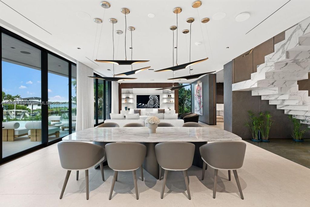 Discover an extraordinary waterfront compound in gated San Souci Estates, featuring a brand new ultra-modern home and a sophisticated guest house on a double lot.