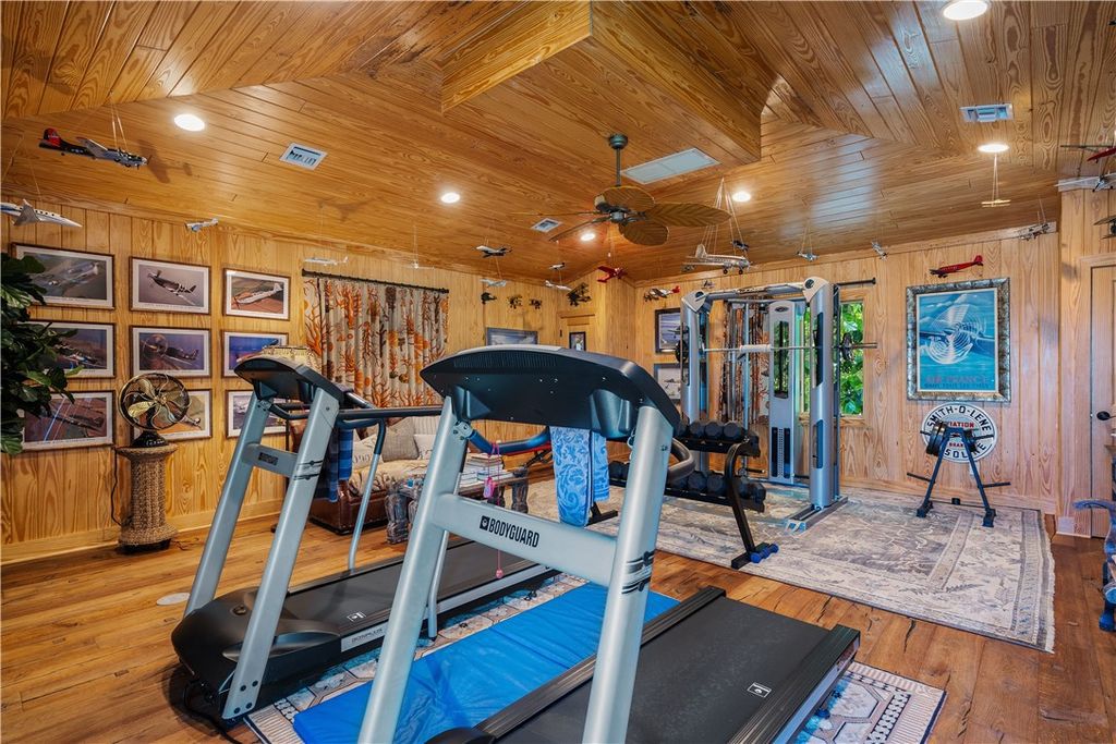 Nestled amid native tropical landscaping, this expansive estate offers a blend of luxury and tranquility. The 1.69-acre estate features a stunning 3,582 square feet main residence with 3 bedrooms and 4 bathrooms, providing ample space for family and guests.