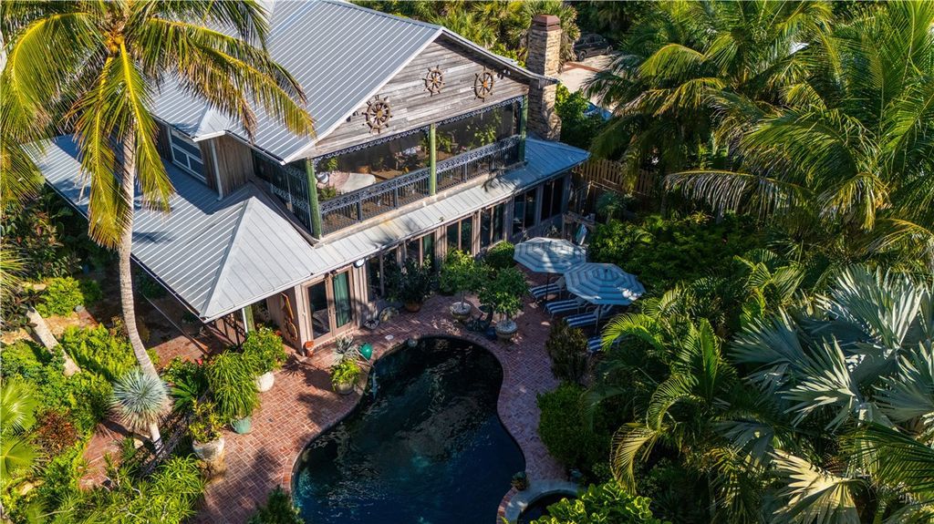 Nestled amid native tropical landscaping, this expansive estate offers a blend of luxury and tranquility. The 1.69-acre estate features a stunning 3,582 square feet main residence with 3 bedrooms and 4 bathrooms, providing ample space for family and guests.