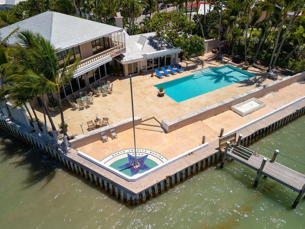 Discover luxury in the Florida Keys with this historic 5-bedroom, 5.5-bathroom home, situated at 400 South St, Key West, FL 33040. Adjacent to the iconic Southernmost Point buoy, this 4,008 square feet residence blends historic charm with modern amenities.