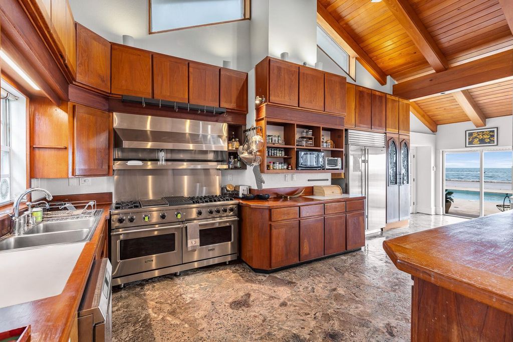 Discover luxury in the Florida Keys with this historic 5-bedroom, 5.5-bathroom home, situated at 400 South St, Key West, FL 33040. Adjacent to the iconic Southernmost Point buoy, this 4,008 square feet residence blends historic charm with modern amenities.