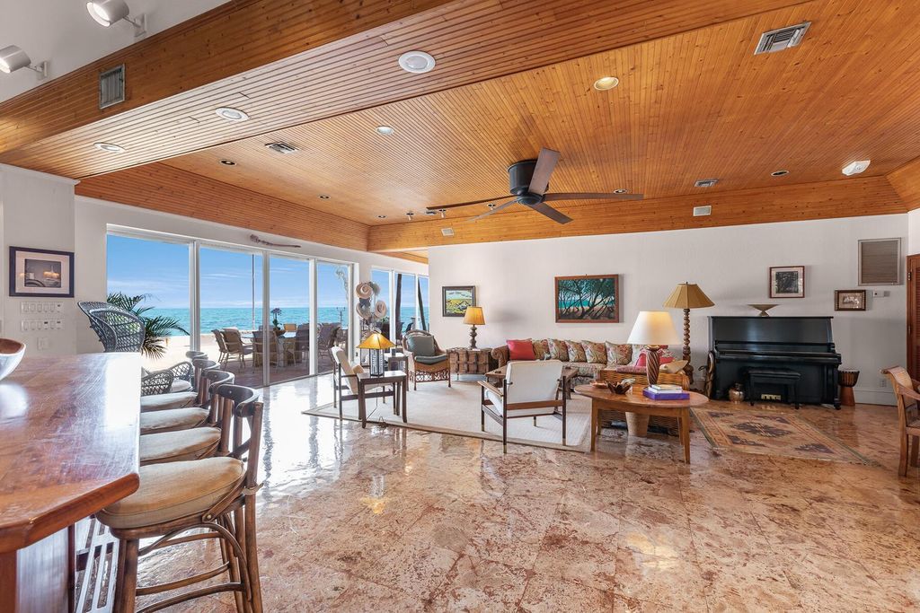 Discover luxury in the Florida Keys with this historic 5-bedroom, 5.5-bathroom home, situated at 400 South St, Key West, FL 33040. Adjacent to the iconic Southernmost Point buoy, this 4,008 square feet residence blends historic charm with modern amenities.