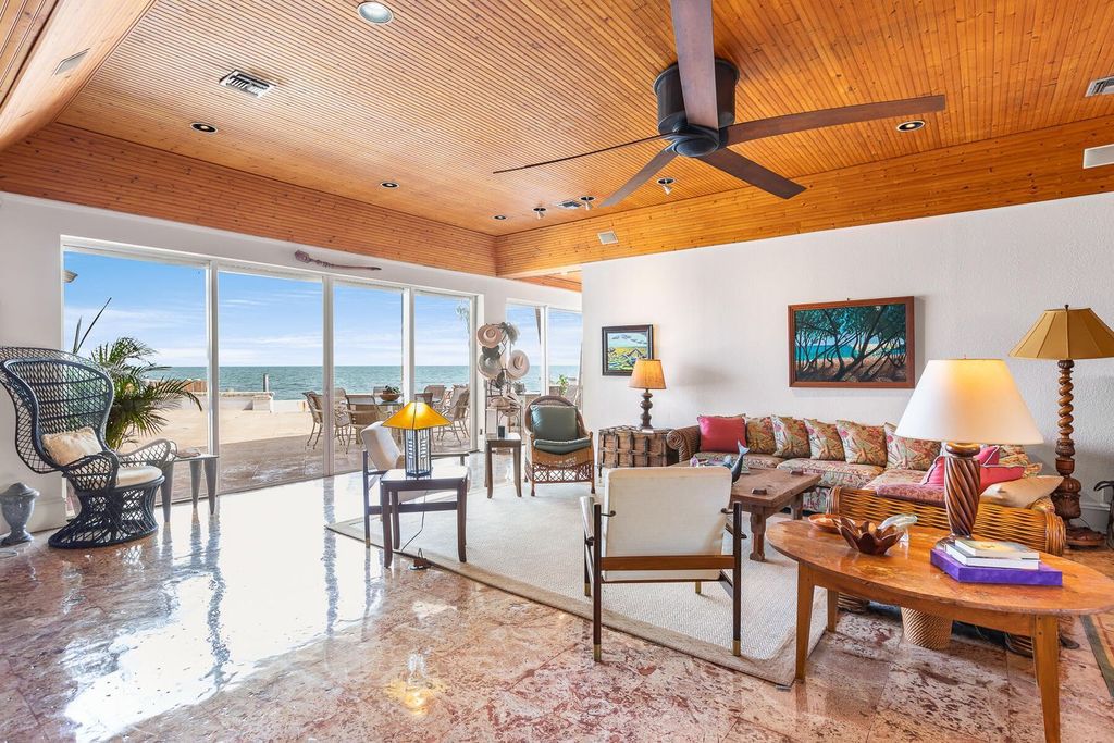 Discover luxury in the Florida Keys with this historic 5-bedroom, 5.5-bathroom home, situated at 400 South St, Key West, FL 33040. Adjacent to the iconic Southernmost Point buoy, this 4,008 square feet residence blends historic charm with modern amenities.
