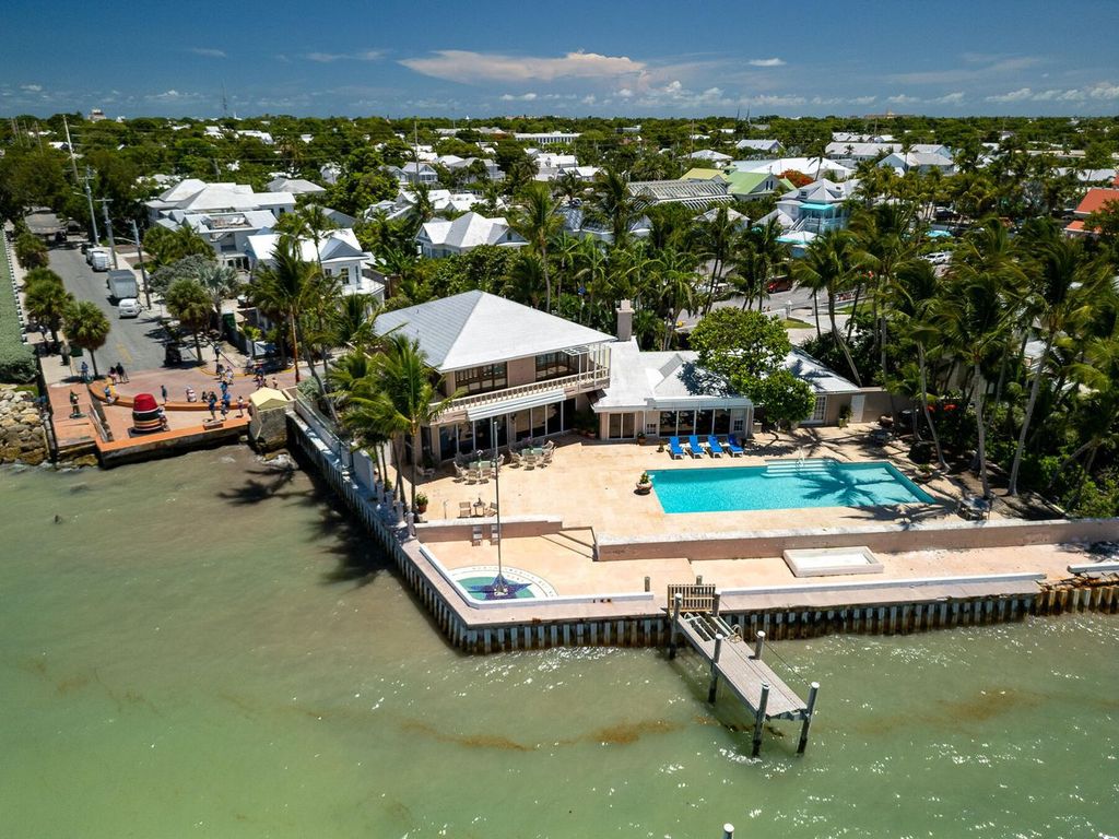 Discover luxury in the Florida Keys with this historic 5-bedroom, 5.5-bathroom home, situated at 400 South St, Key West, FL 33040. Adjacent to the iconic Southernmost Point buoy, this 4,008 square feet residence blends historic charm with modern amenities.