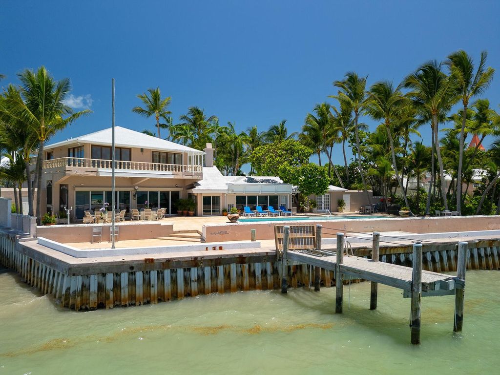 Discover luxury in the Florida Keys with this historic 5-bedroom, 5.5-bathroom home, situated at 400 South St, Key West, FL 33040. Adjacent to the iconic Southernmost Point buoy, this 4,008 square feet residence blends historic charm with modern amenities.
