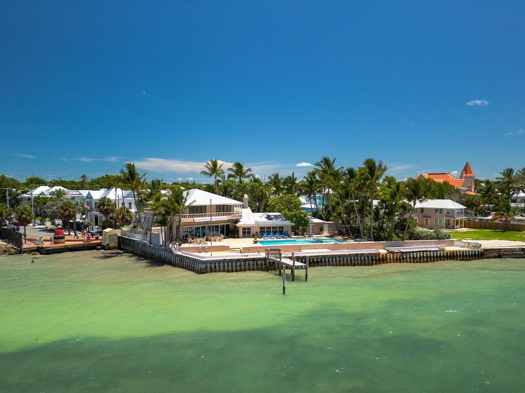 Discover luxury in the Florida Keys with this historic 5-bedroom, 5.5-bathroom home, situated at 400 South St, Key West, FL 33040. Adjacent to the iconic Southernmost Point buoy, this 4,008 square feet residence blends historic charm with modern amenities.