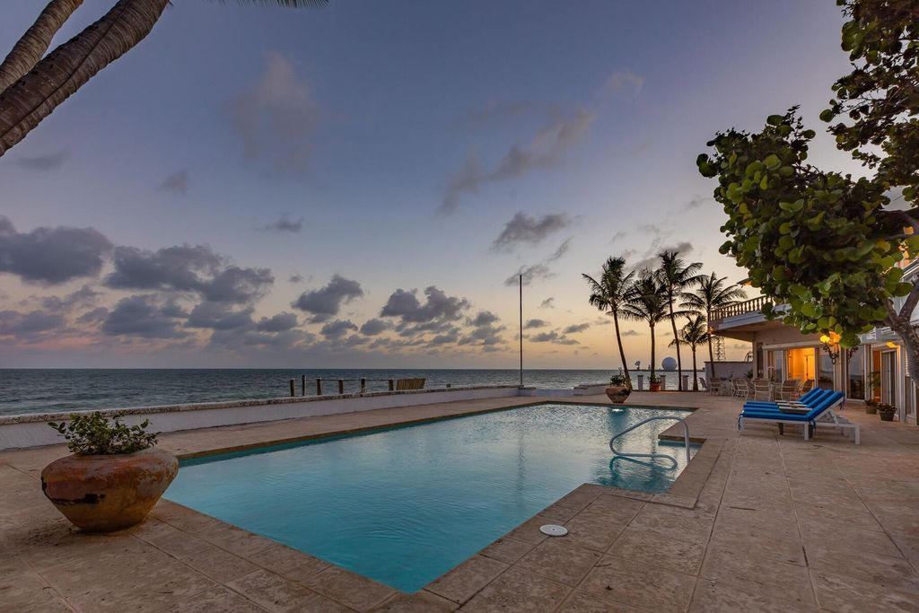 Discover luxury in the Florida Keys with this historic 5-bedroom, 5.5-bathroom home, situated at 400 South St, Key West, FL 33040. Adjacent to the iconic Southernmost Point buoy, this 4,008 square feet residence blends historic charm with modern amenities.