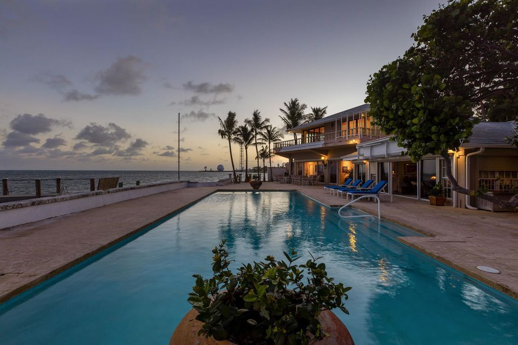 Discover luxury in the Florida Keys with this historic 5-bedroom, 5.5-bathroom home, situated at 400 South St, Key West, FL 33040. Adjacent to the iconic Southernmost Point buoy, this 4,008 square feet residence blends historic charm with modern amenities.