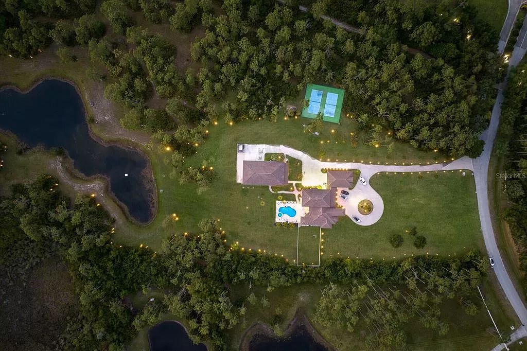 Nestled within the prestigious equestrian community of Foxwood at Panther Ridge, this extraordinary 13-acre estate offers unparalleled luxury country living.
