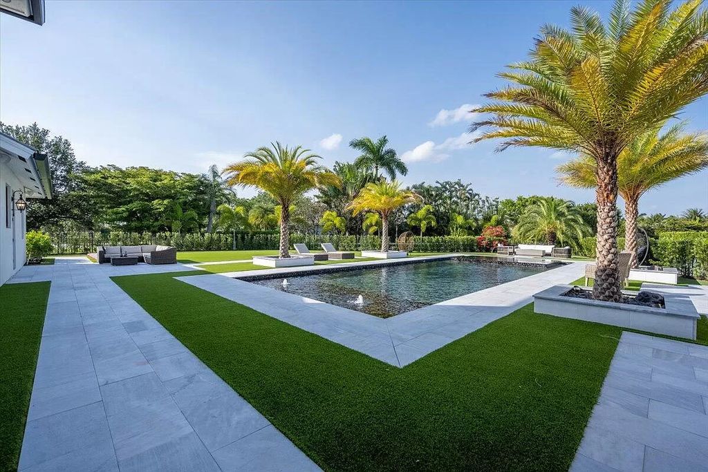 Welcome to this luxurious estate in the prestigious Aero Club. Featuring 7 bedrooms, 8 1/2 bathrooms, and 3 1/2 kitchens, this home is designed for ultimate comfort.