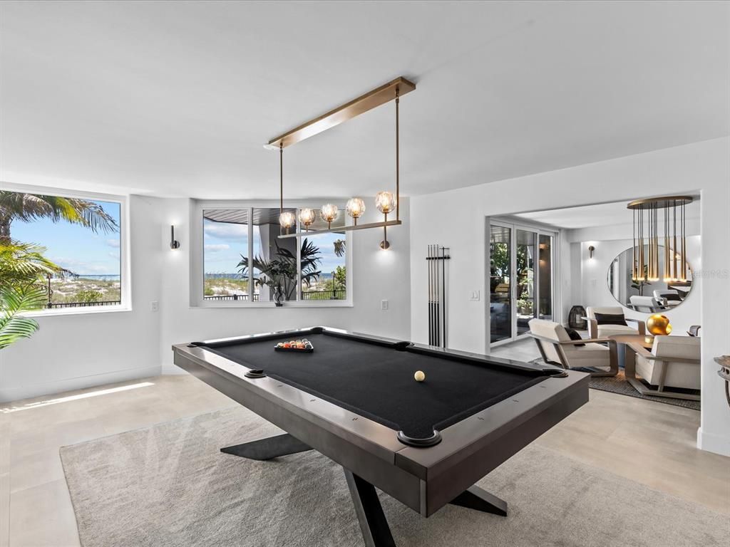 Enjoy modern elegance with breathtaking ocean views, a gourmet kitchen with marble countertops, a state-of-the-art water vapor fireplace, and over 10 TVs.