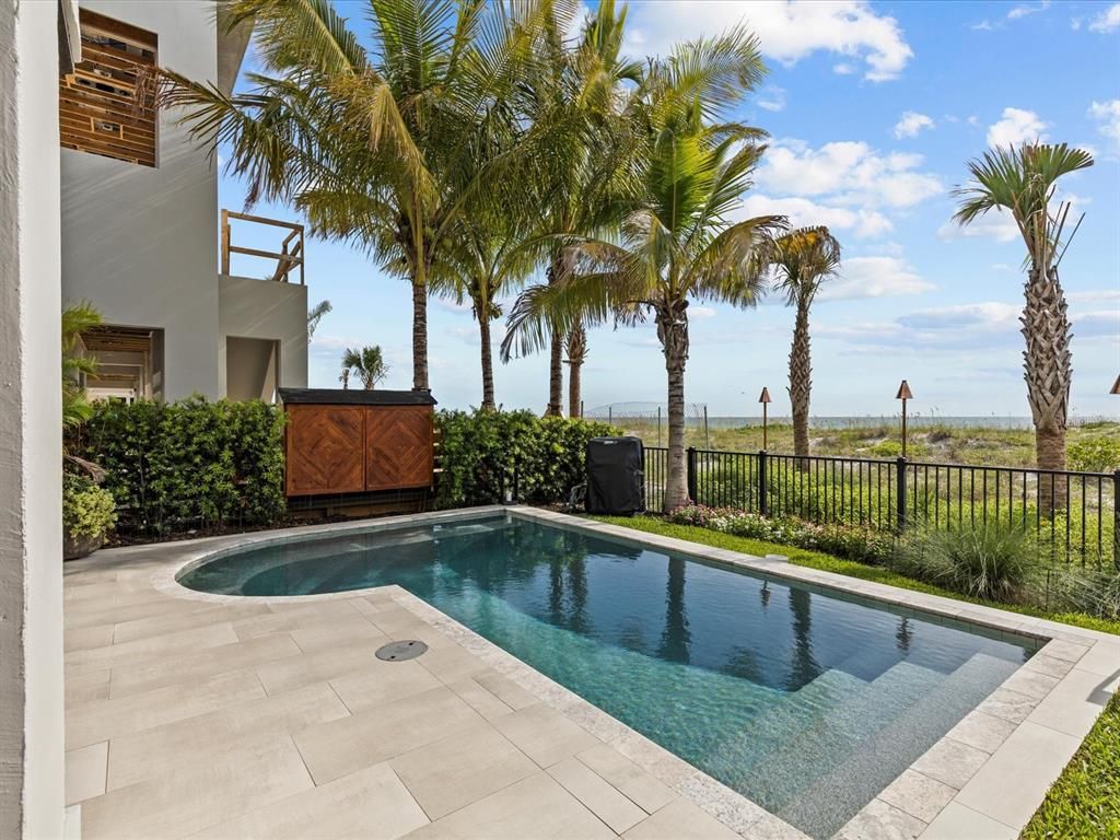 Enjoy modern elegance with breathtaking ocean views, a gourmet kitchen with marble countertops, a state-of-the-art water vapor fireplace, and over 10 TVs.