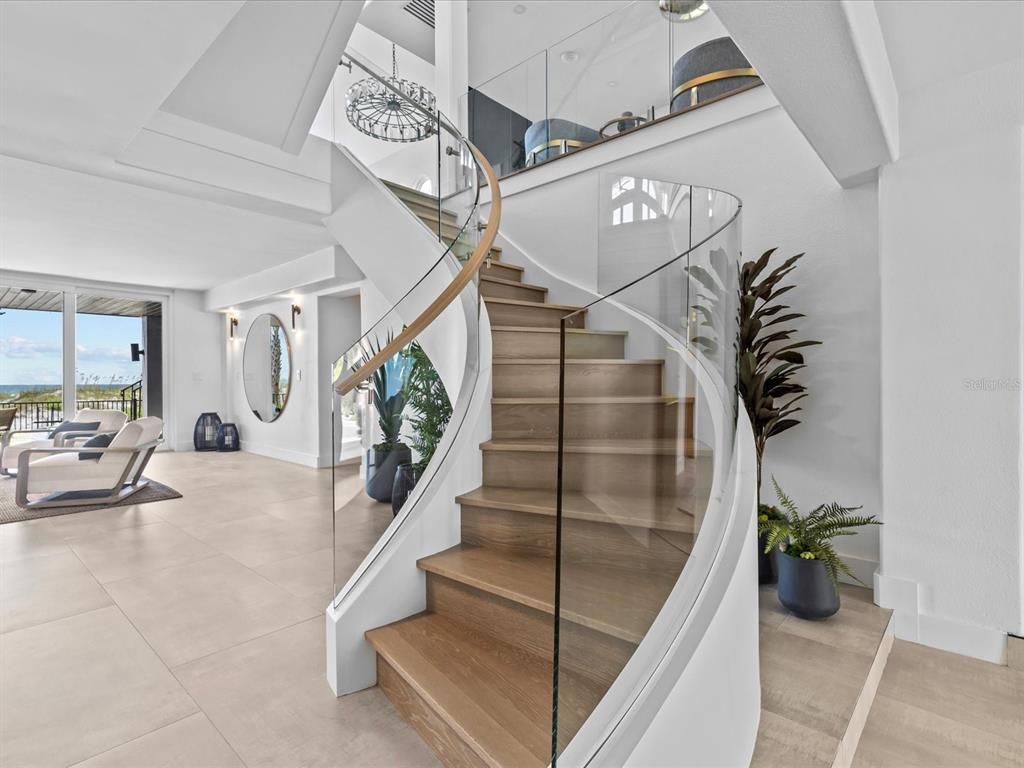 Enjoy modern elegance with breathtaking ocean views, a gourmet kitchen with marble countertops, a state-of-the-art water vapor fireplace, and over 10 TVs.