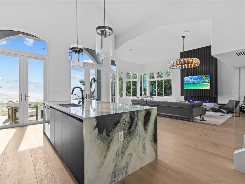 Enjoy modern elegance with breathtaking ocean views, a gourmet kitchen with marble countertops, a state-of-the-art water vapor fireplace, and over 10 TVs.
