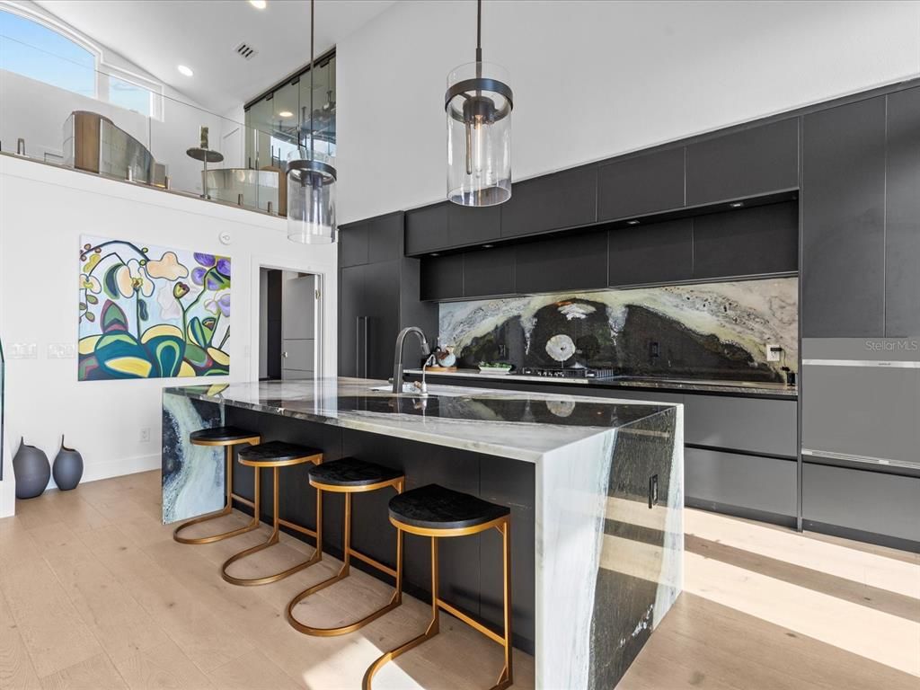 Enjoy modern elegance with breathtaking ocean views, a gourmet kitchen with marble countertops, a state-of-the-art water vapor fireplace, and over 10 TVs.