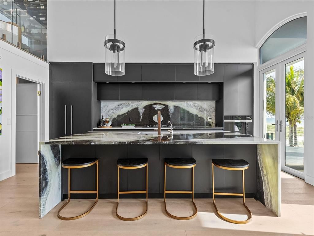 Enjoy modern elegance with breathtaking ocean views, a gourmet kitchen with marble countertops, a state-of-the-art water vapor fireplace, and over 10 TVs.