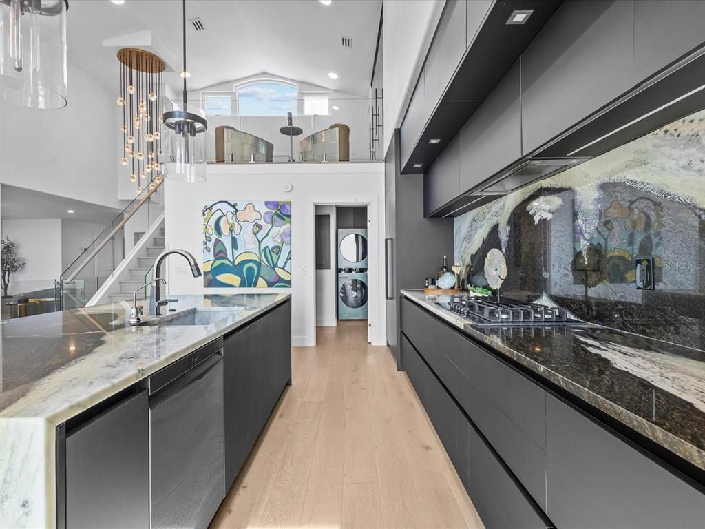 Enjoy modern elegance with breathtaking ocean views, a gourmet kitchen with marble countertops, a state-of-the-art water vapor fireplace, and over 10 TVs.