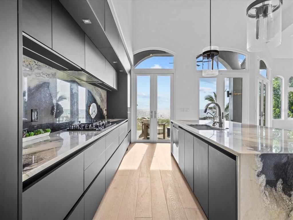 Enjoy modern elegance with breathtaking ocean views, a gourmet kitchen with marble countertops, a state-of-the-art water vapor fireplace, and over 10 TVs.