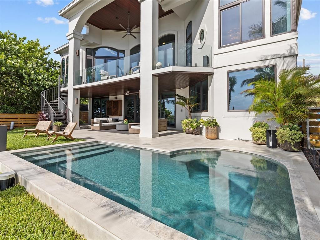 Enjoy modern elegance with breathtaking ocean views, a gourmet kitchen with marble countertops, a state-of-the-art water vapor fireplace, and over 10 TVs.