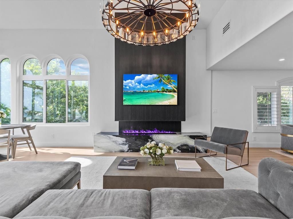 Enjoy modern elegance with breathtaking ocean views, a gourmet kitchen with marble countertops, a state-of-the-art water vapor fireplace, and over 10 TVs.