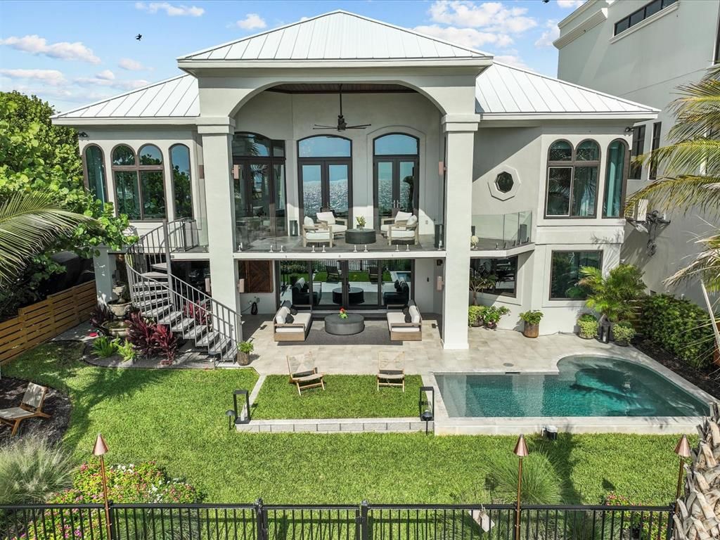 Enjoy modern elegance with breathtaking ocean views, a gourmet kitchen with marble countertops, a state-of-the-art water vapor fireplace, and over 10 TVs.