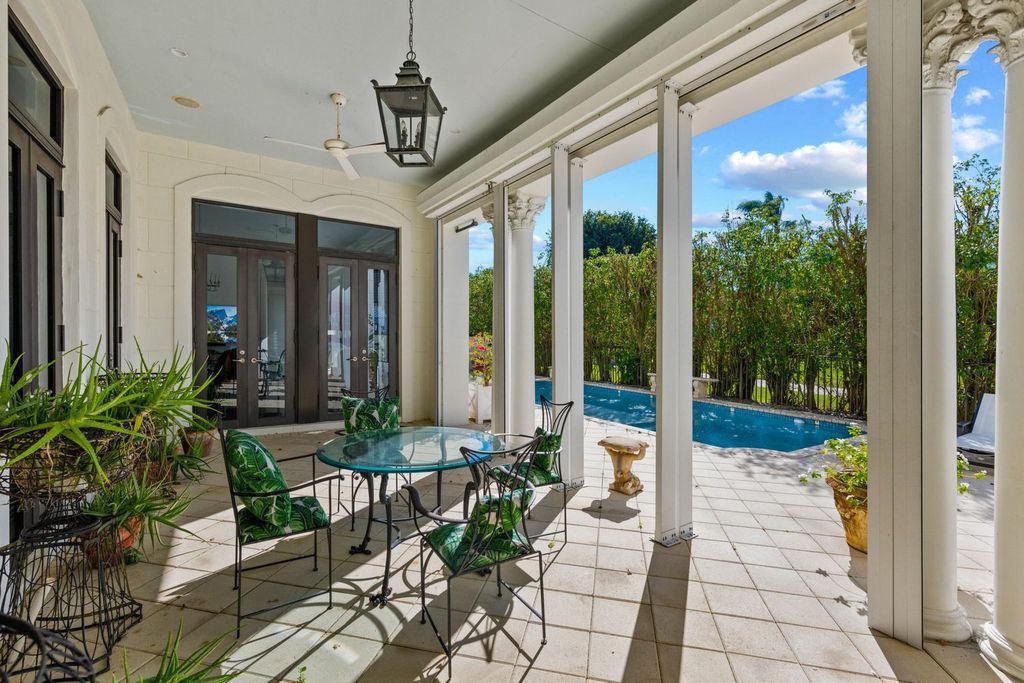 This 6-bedroom, 6.5-bathroom masterpiece, inspired by classic European estates, boasts soaring ceilings, a sweeping staircase, and grand living spaces including formal living and dining rooms, a den, and a separate bar.