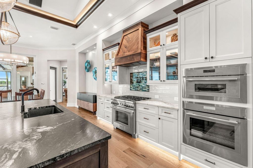 This brand-new 2024 lakefront estate, set on 0.75 acres, offers 4 bedrooms, 7 baths, and 6,299 square feet of refined living space.