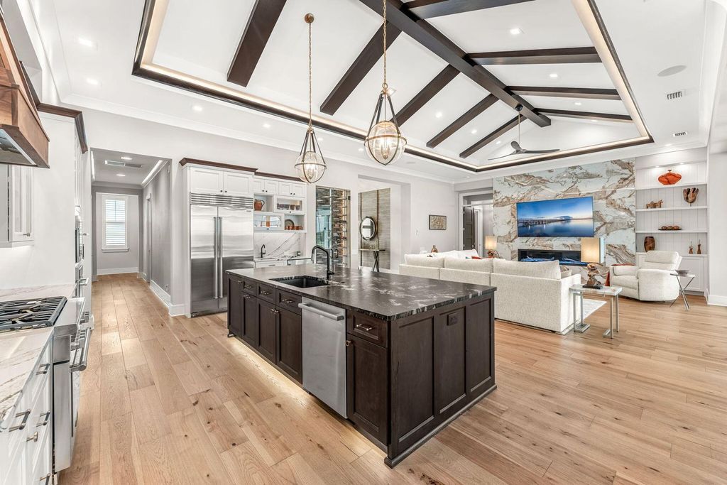 This brand-new 2024 lakefront estate, set on 0.75 acres, offers 4 bedrooms, 7 baths, and 6,299 square feet of refined living space.