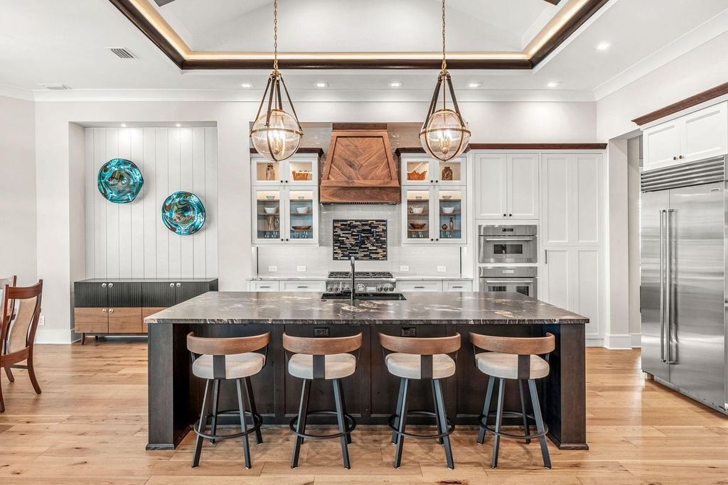 This brand-new 2024 lakefront estate, set on 0.75 acres, offers 4 bedrooms, 7 baths, and 6,299 square feet of refined living space.