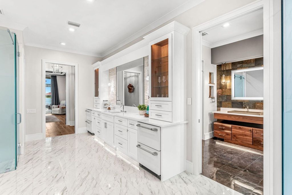 This brand-new 2024 lakefront estate, set on 0.75 acres, offers 4 bedrooms, 7 baths, and 6,299 square feet of refined living space.
