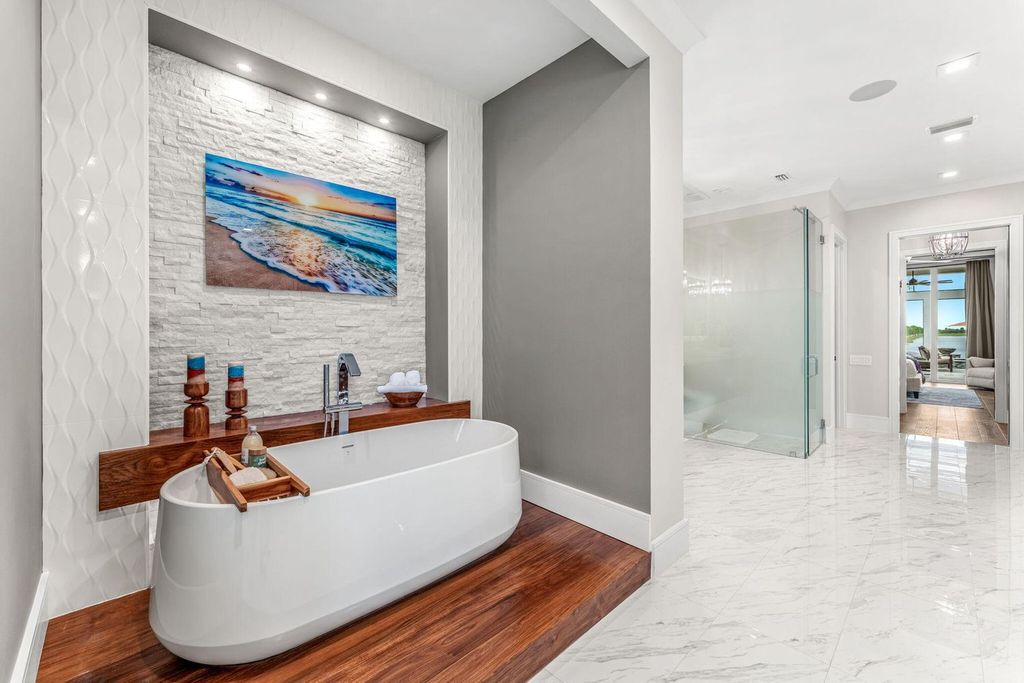 This brand-new 2024 lakefront estate, set on 0.75 acres, offers 4 bedrooms, 7 baths, and 6,299 square feet of refined living space.