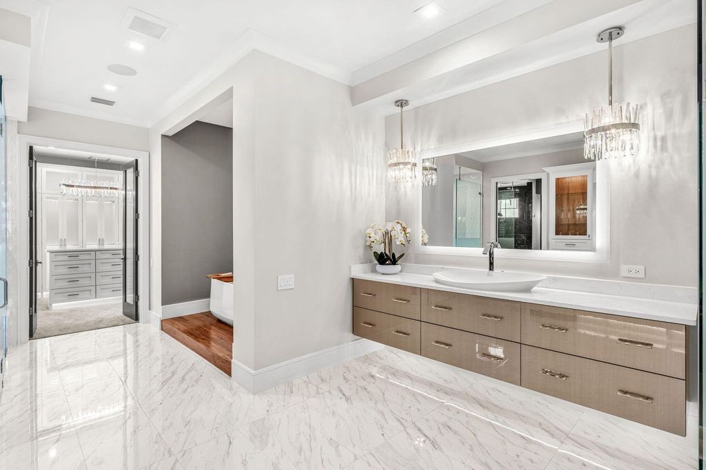 This brand-new 2024 lakefront estate, set on 0.75 acres, offers 4 bedrooms, 7 baths, and 6,299 square feet of refined living space.