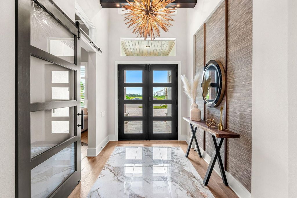 This brand-new 2024 lakefront estate, set on 0.75 acres, offers 4 bedrooms, 7 baths, and 6,299 square feet of refined living space.