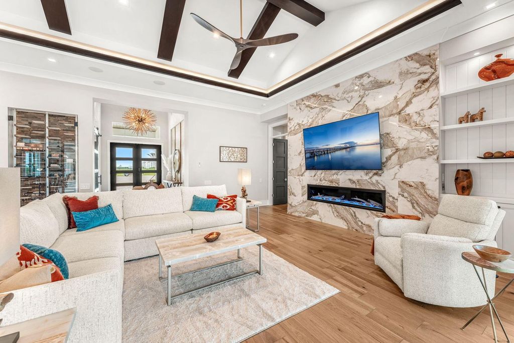 This brand-new 2024 lakefront estate, set on 0.75 acres, offers 4 bedrooms, 7 baths, and 6,299 square feet of refined living space.