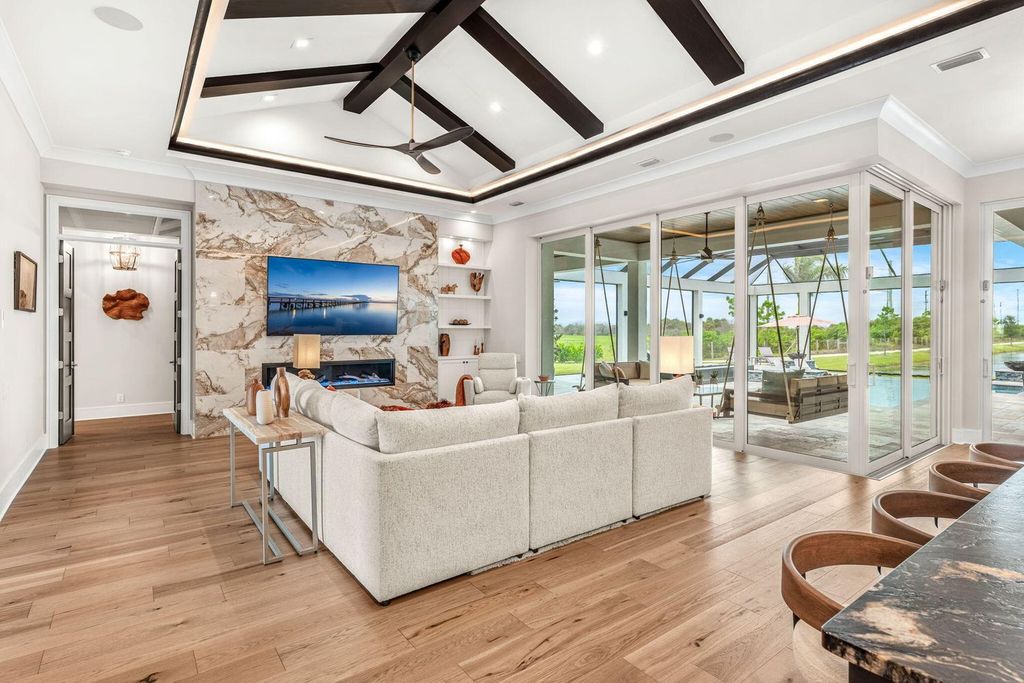 This brand-new 2024 lakefront estate, set on 0.75 acres, offers 4 bedrooms, 7 baths, and 6,299 square feet of refined living space.