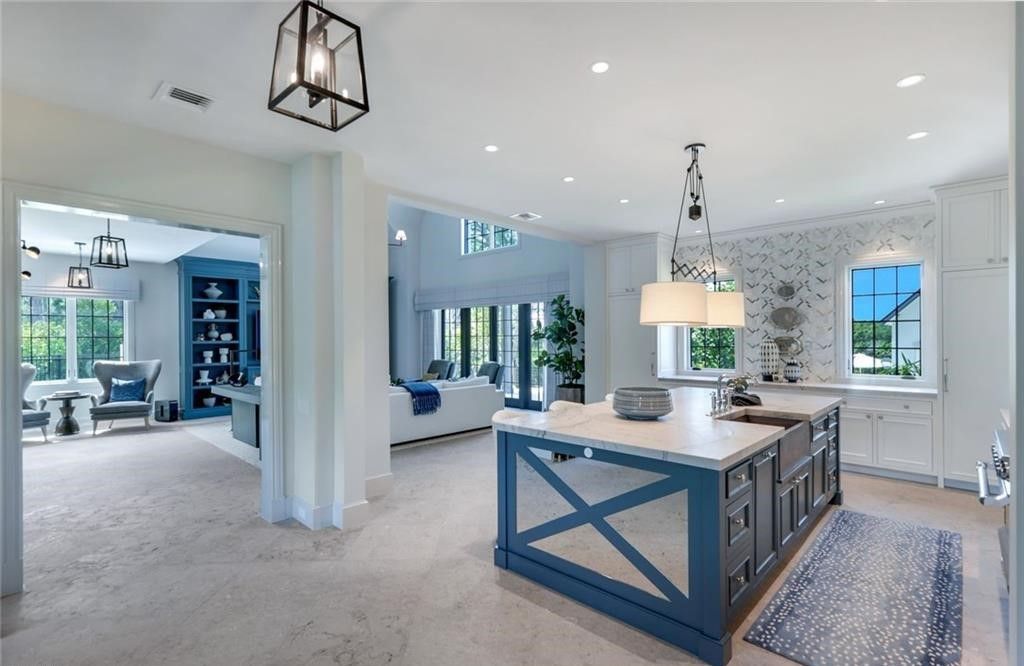 Set on nearly an acre in Audubon Country Club, this 4-bed, 6-bath home, designed by Renee Gaddis and built by the Williams Group, blends modern art deco with French countryside charm.