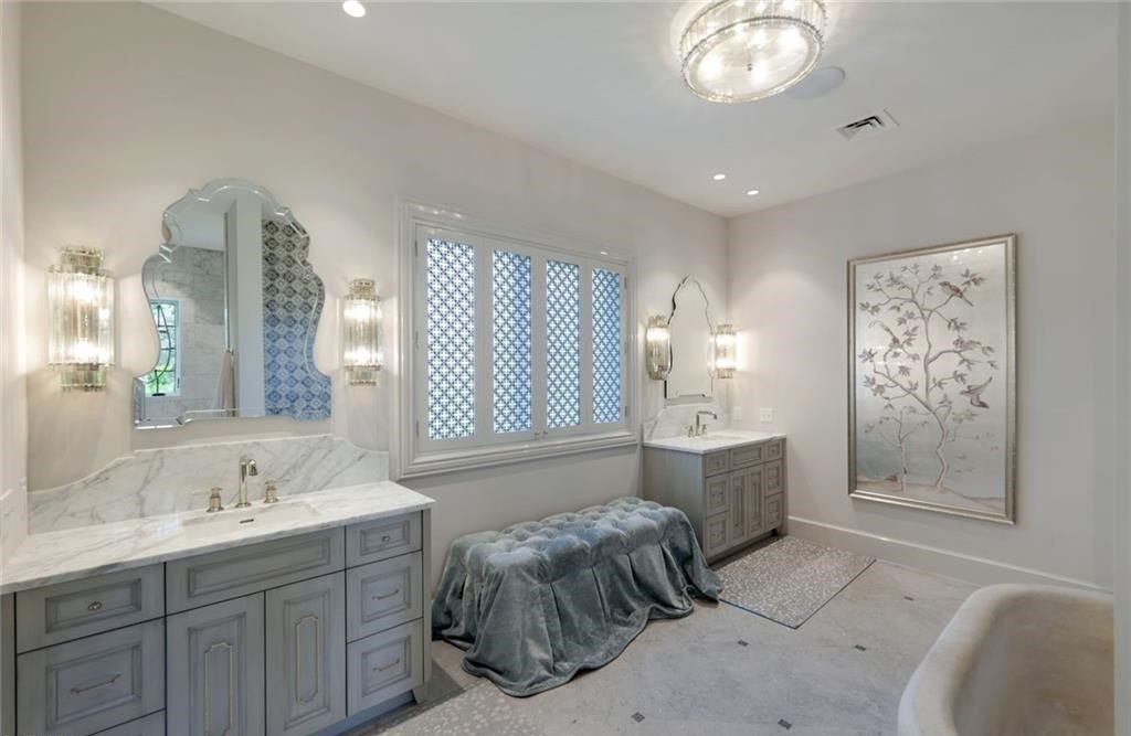 Set on nearly an acre in Audubon Country Club, this 4-bed, 6-bath home, designed by Renee Gaddis and built by the Williams Group, blends modern art deco with French countryside charm.