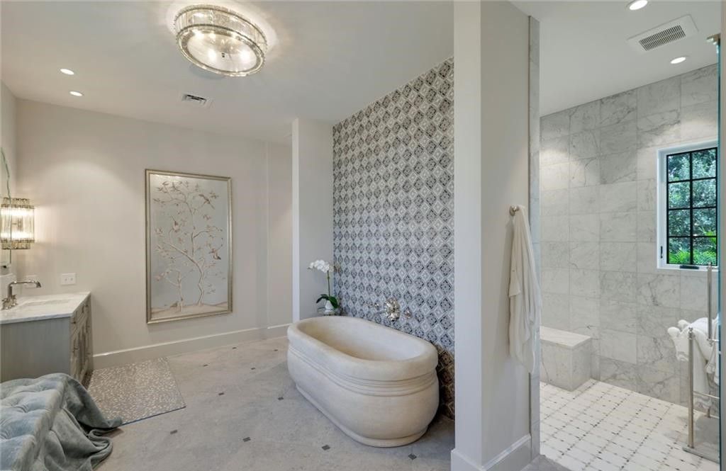 Set on nearly an acre in Audubon Country Club, this 4-bed, 6-bath home, designed by Renee Gaddis and built by the Williams Group, blends modern art deco with French countryside charm.