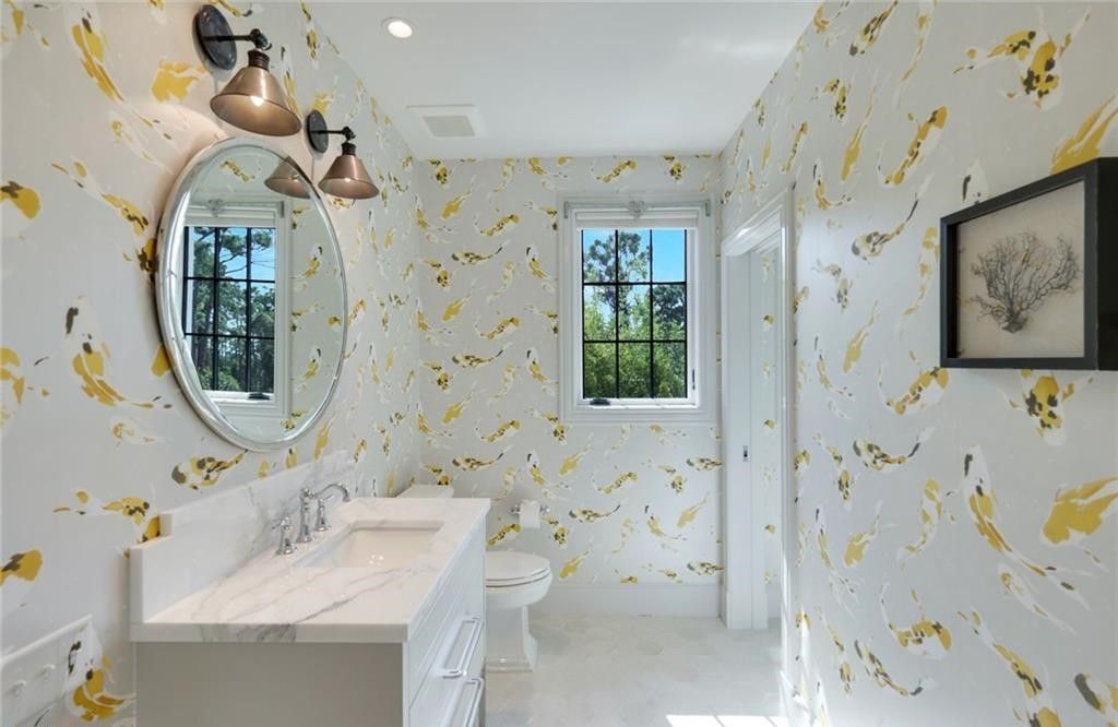 Set on nearly an acre in Audubon Country Club, this 4-bed, 6-bath home, designed by Renee Gaddis and built by the Williams Group, blends modern art deco with French countryside charm.