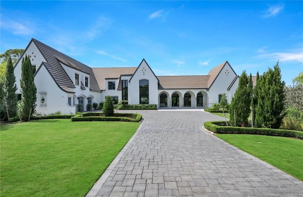 Set on nearly an acre in Audubon Country Club, this 4-bed, 6-bath home, designed by Renee Gaddis and built by the Williams Group, blends modern art deco with French countryside charm.