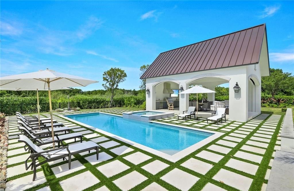 Set on nearly an acre in Audubon Country Club, this 4-bed, 6-bath home, designed by Renee Gaddis and built by the Williams Group, blends modern art deco with French countryside charm.