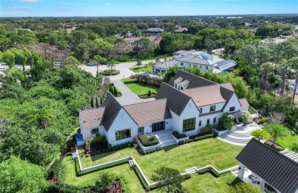 Set on nearly an acre in Audubon Country Club, this 4-bed, 6-bath home, designed by Renee Gaddis and built by the Williams Group, blends modern art deco with French countryside charm.
