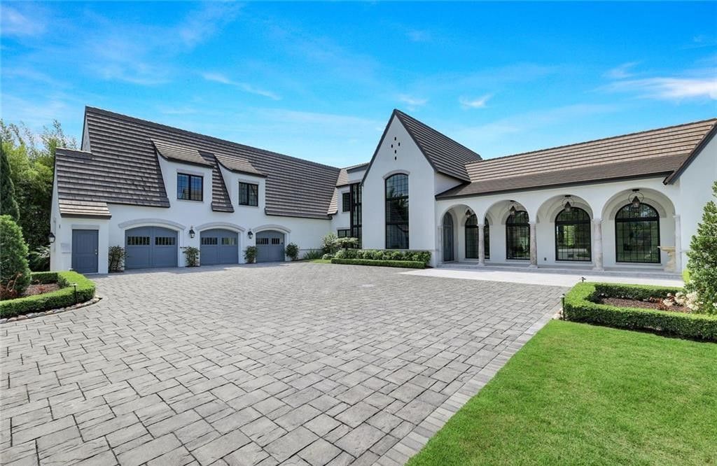 Set on nearly an acre in Audubon Country Club, this 4-bed, 6-bath home, designed by Renee Gaddis and built by the Williams Group, blends modern art deco with French countryside charm.