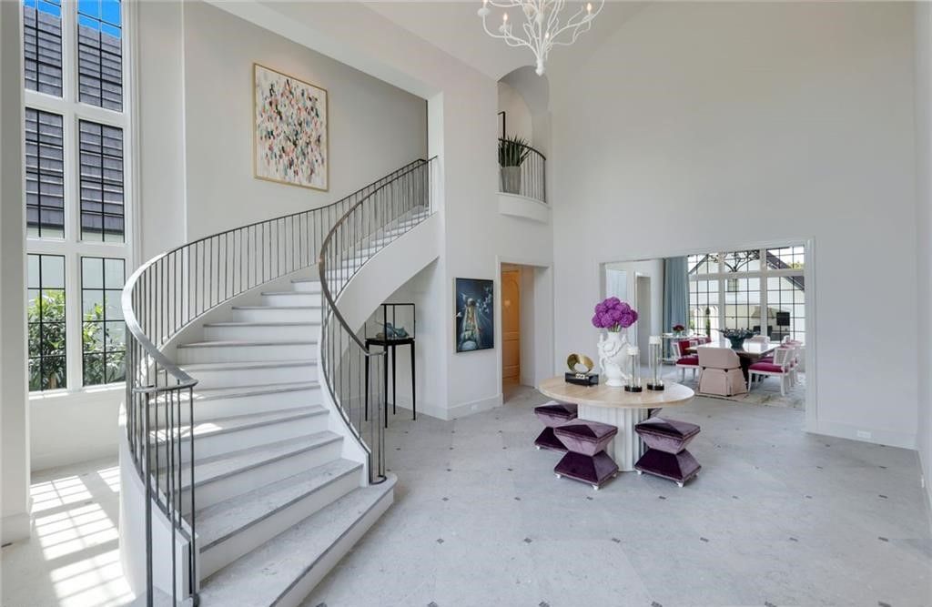 Set on nearly an acre in Audubon Country Club, this 4-bed, 6-bath home, designed by Renee Gaddis and built by the Williams Group, blends modern art deco with French countryside charm.