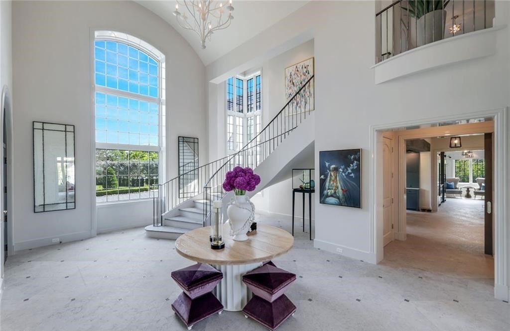 Set on nearly an acre in Audubon Country Club, this 4-bed, 6-bath home, designed by Renee Gaddis and built by the Williams Group, blends modern art deco with French countryside charm.